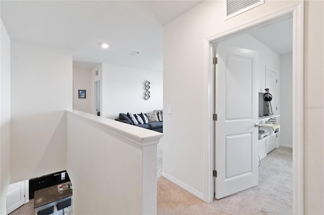 corridor with light colored carpet