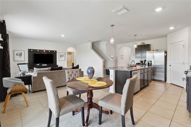 dining space with light tile patterned floors and sink