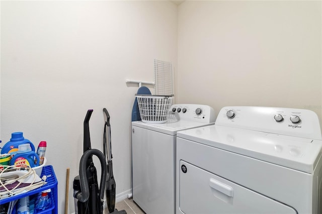 laundry room featuring separate washer and dryer and light tile patterned floors