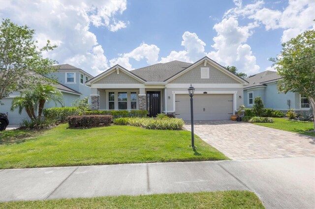 craftsman-style house featuring a garage and a front lawn