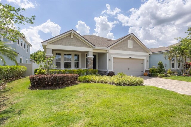 craftsman house with a front yard and a garage