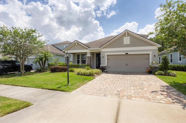 craftsman house with a garage and a front lawn