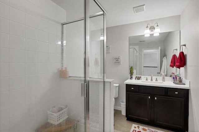 bathroom with tile patterned flooring, an enclosed shower, vanity, and toilet