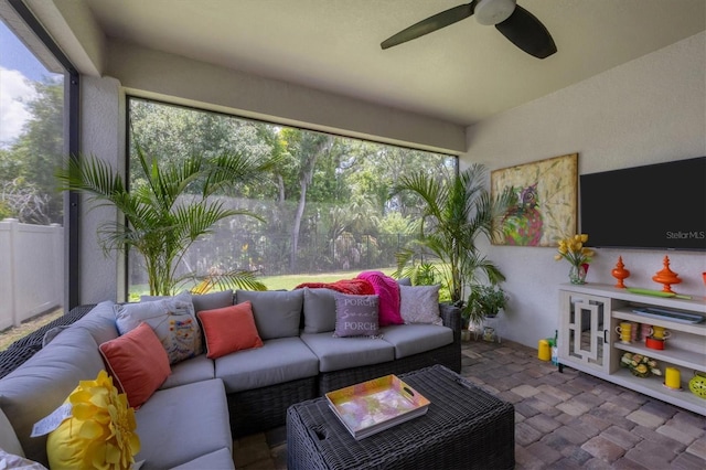 sunroom / solarium featuring ceiling fan and a healthy amount of sunlight