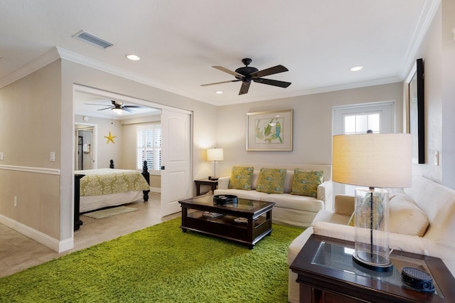 living room with ceiling fan and ornamental molding