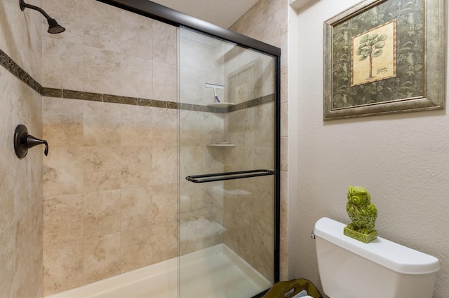 bathroom with an enclosed shower and toilet