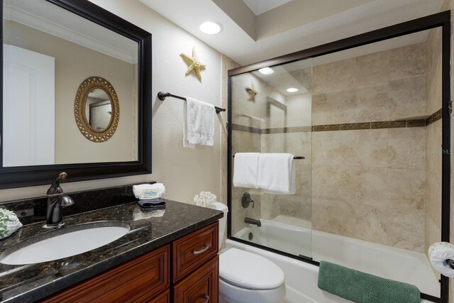 full bathroom with vanity, toilet, and bath / shower combo with glass door