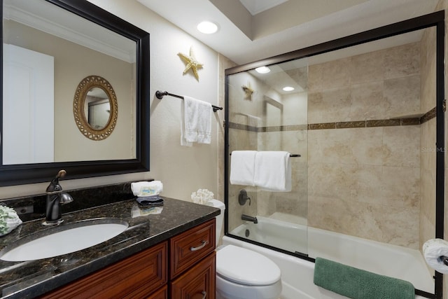 full bathroom with ornamental molding, enclosed tub / shower combo, vanity, and toilet