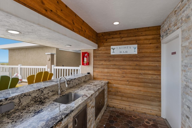 kitchen with sink and light stone countertops