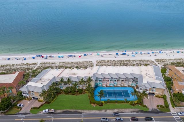 birds eye view of property with a water view and a view of the beach