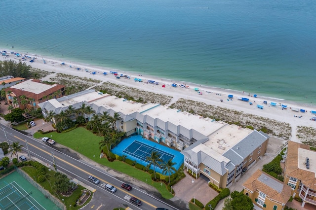 drone / aerial view featuring a water view and a view of the beach