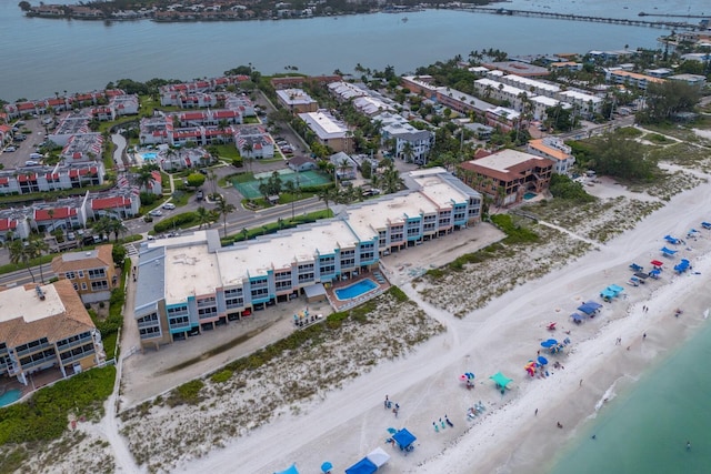 bird's eye view featuring a water view and a beach view