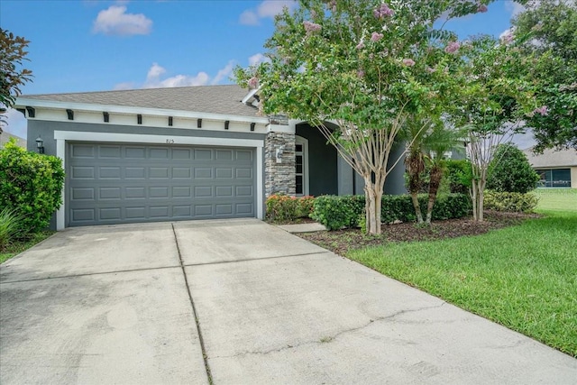 view of front of home featuring a garage and a front yard