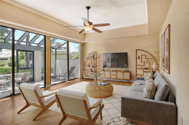 living room featuring a textured ceiling, light hardwood / wood-style floors, and ceiling fan