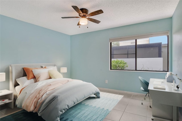 tiled bedroom featuring ceiling fan and a textured ceiling