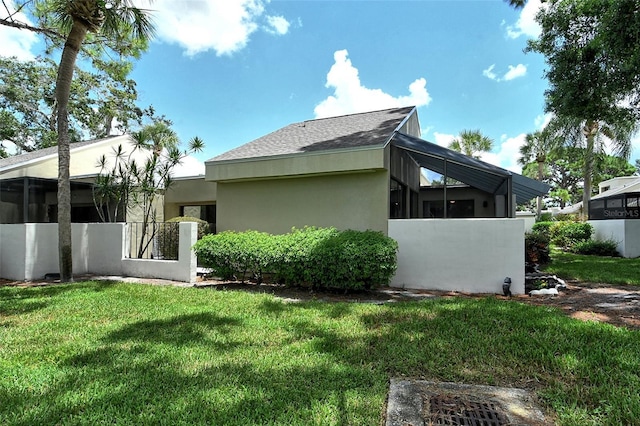 rear view of house featuring a lawn