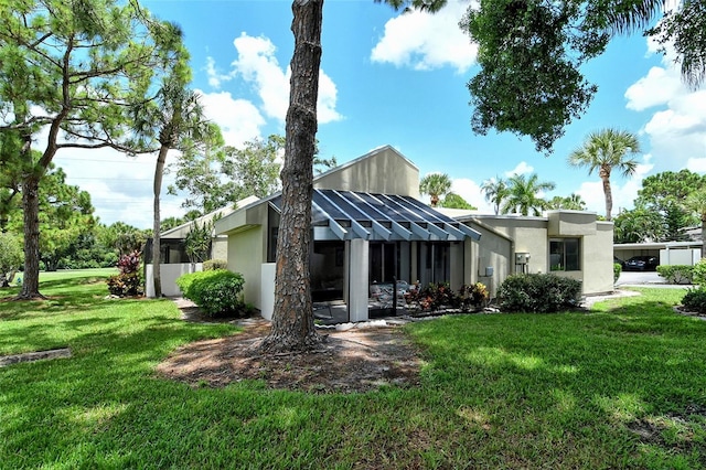 rear view of house featuring a lawn