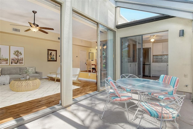 sunroom / solarium featuring ceiling fan