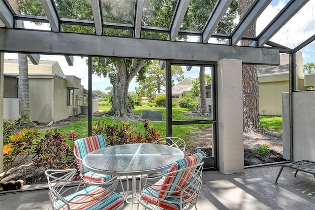 sunroom featuring a wealth of natural light and a skylight