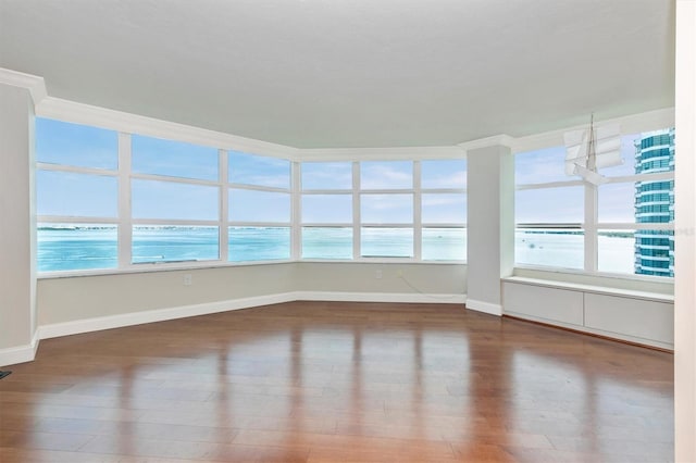 unfurnished sunroom with plenty of natural light and a water view