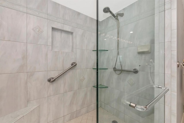 bathroom featuring a shower with shower door