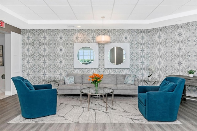 living room featuring hardwood / wood-style flooring and a drop ceiling