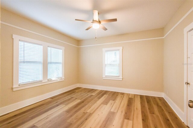 spare room featuring wood-type flooring and ceiling fan