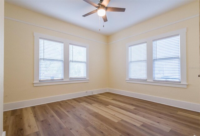 spare room with light wood-type flooring and ceiling fan