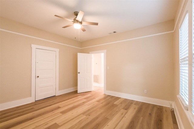 unfurnished bedroom featuring a closet, light hardwood / wood-style floors, and ceiling fan