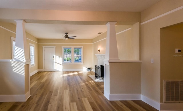 unfurnished living room featuring ceiling fan and hardwood / wood-style floors