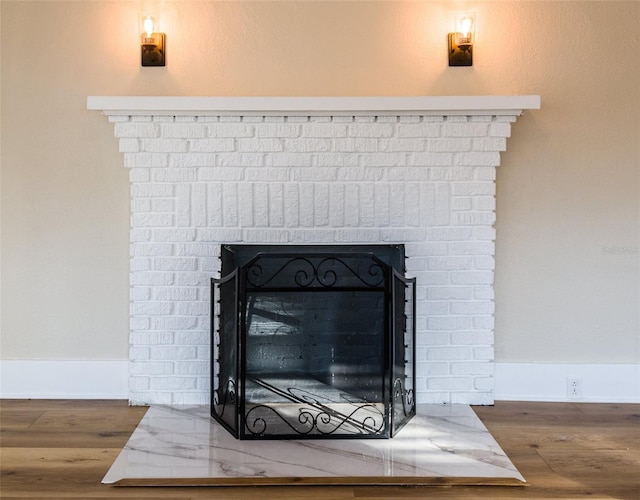 details with hardwood / wood-style floors and a fireplace