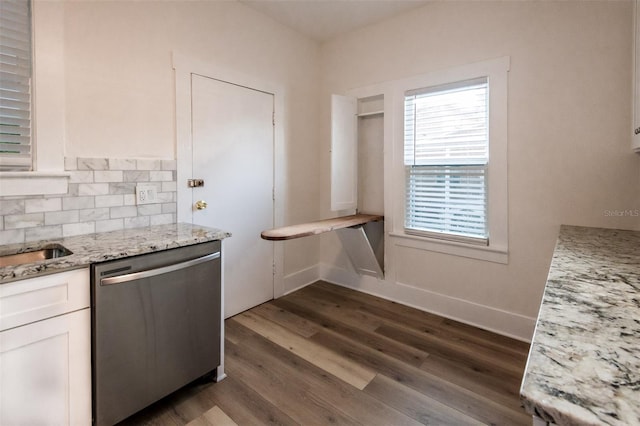 kitchen with decorative backsplash, dark hardwood / wood-style flooring, light stone counters, dishwasher, and white cabinetry