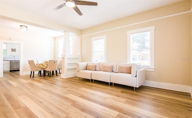 living room featuring ceiling fan and light hardwood / wood-style flooring