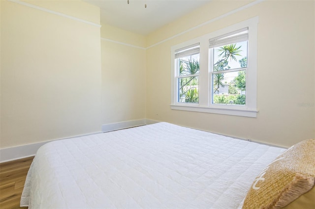 bedroom with hardwood / wood-style flooring