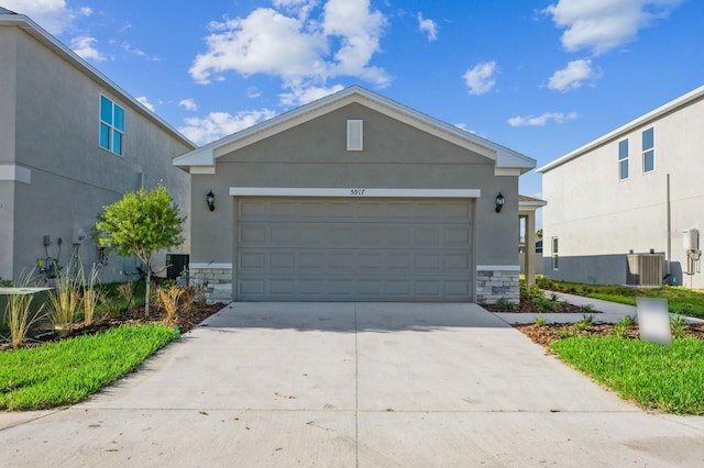 view of front of house with central AC and a garage