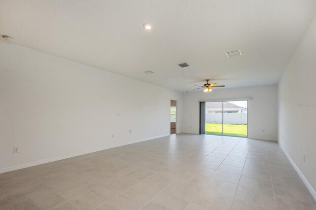 unfurnished room featuring light tile patterned floors and ceiling fan