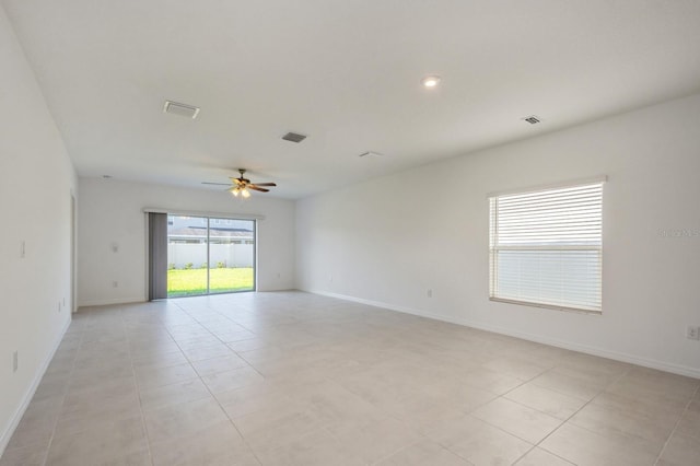 unfurnished room with ceiling fan and light tile patterned floors