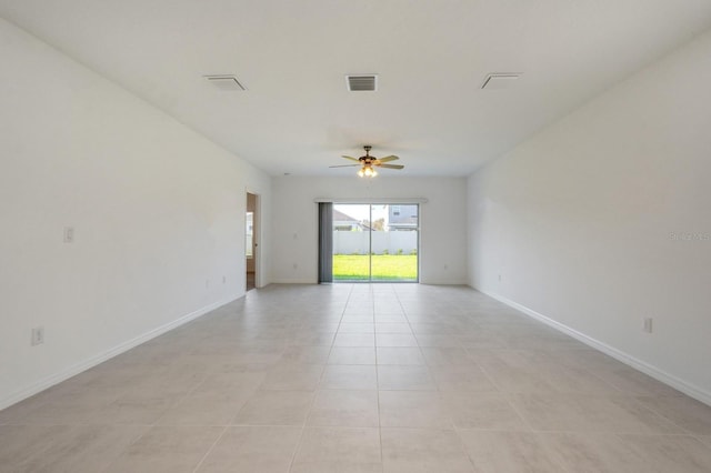 tiled spare room with ceiling fan