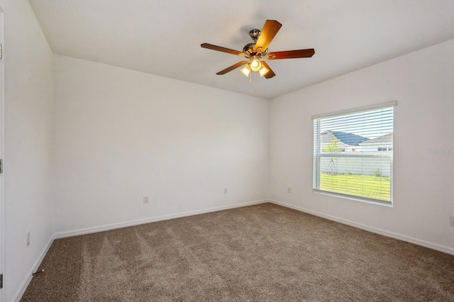 carpeted empty room featuring ceiling fan