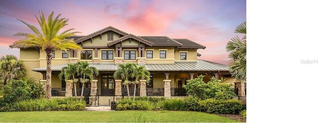 craftsman-style home with covered porch and a yard