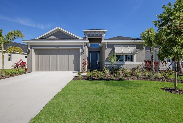 view of front of house with a garage and a front lawn