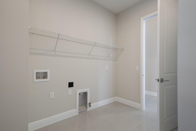 laundry room featuring electric dryer hookup, tile patterned flooring, and washer hookup