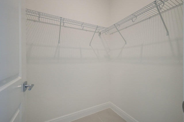 spacious closet featuring tile patterned flooring