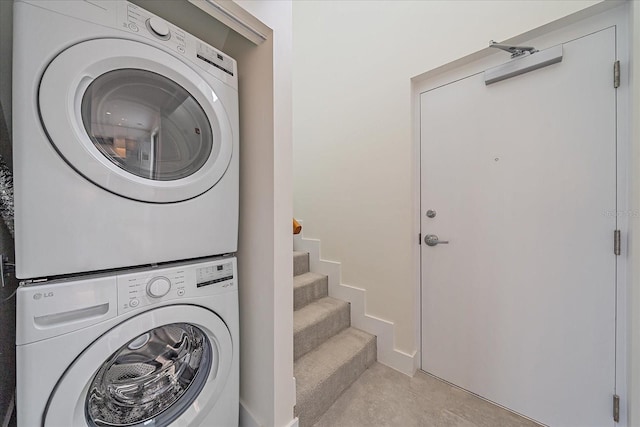 laundry room with stacked washer / drying machine and laundry area