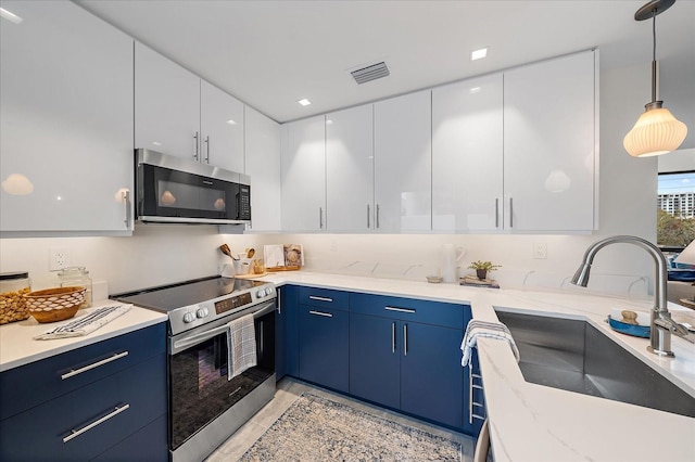 kitchen with light stone countertops, white cabinets, appliances with stainless steel finishes, decorative light fixtures, and blue cabinets