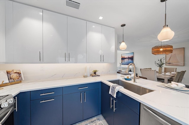 kitchen with pendant lighting, white cabinetry, stainless steel appliances, sink, and light stone counters