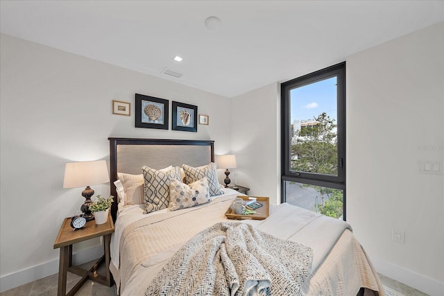 bedroom featuring multiple windows and expansive windows