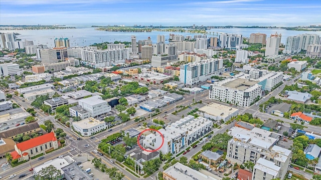 birds eye view of property with a view of city and a water view