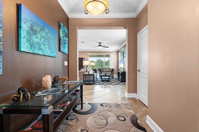 hallway with ornamental molding and light tile patterned floors