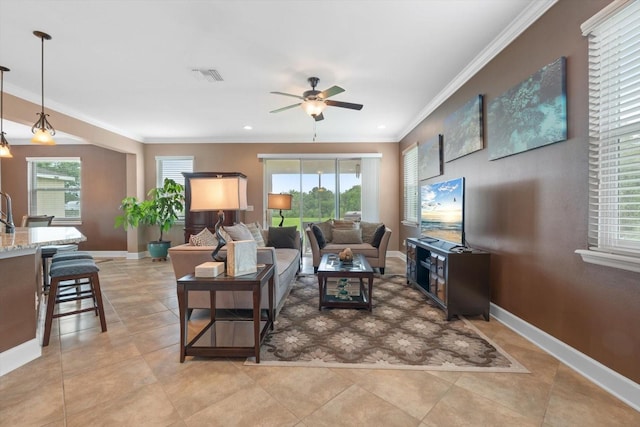 tiled living room featuring crown molding, ceiling fan, and a wealth of natural light